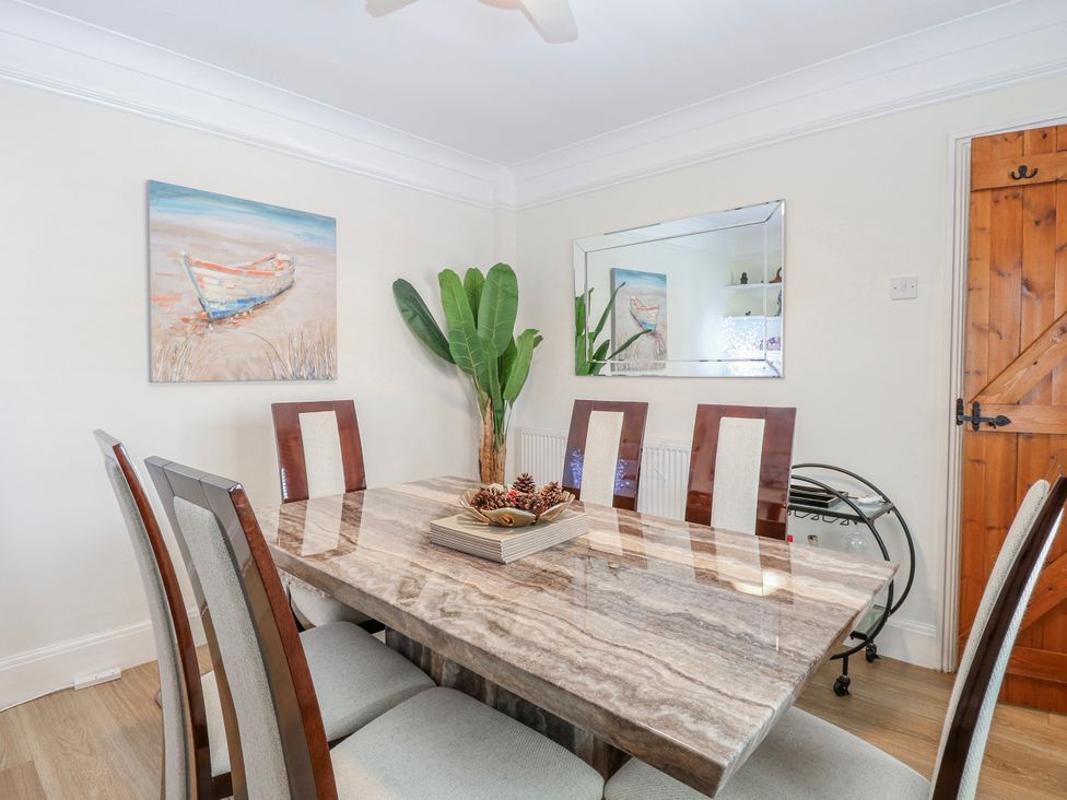 A dining room with a table and chairs at 17 Woodside Avenue in King's Lynn