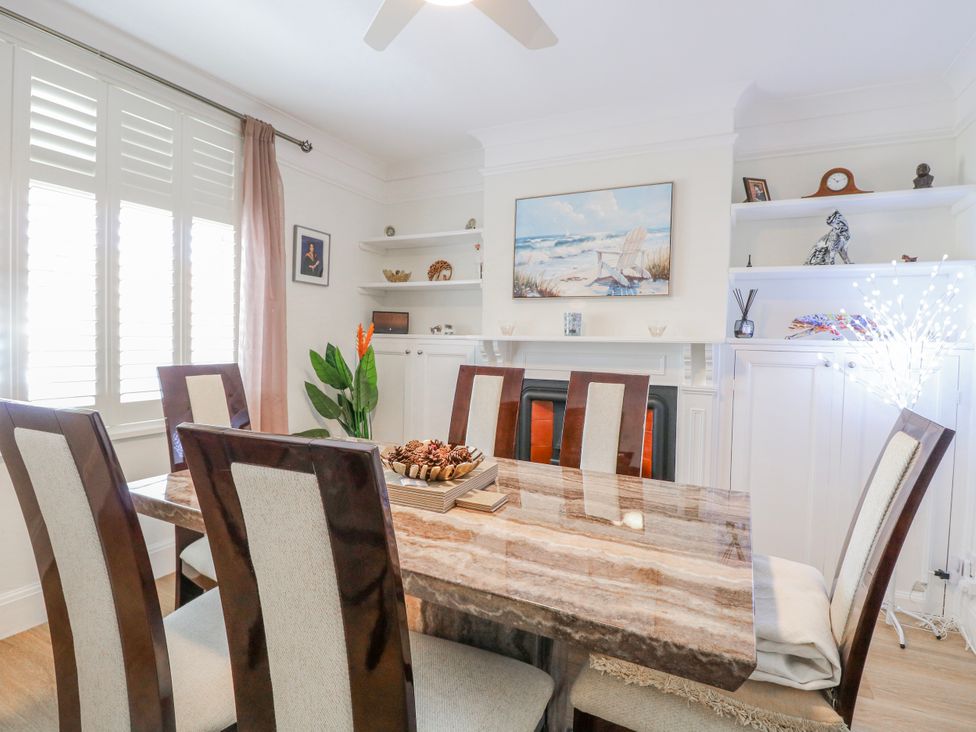 A dining room with a table and chairs at 17 Woodside Avenue in King's Lynn