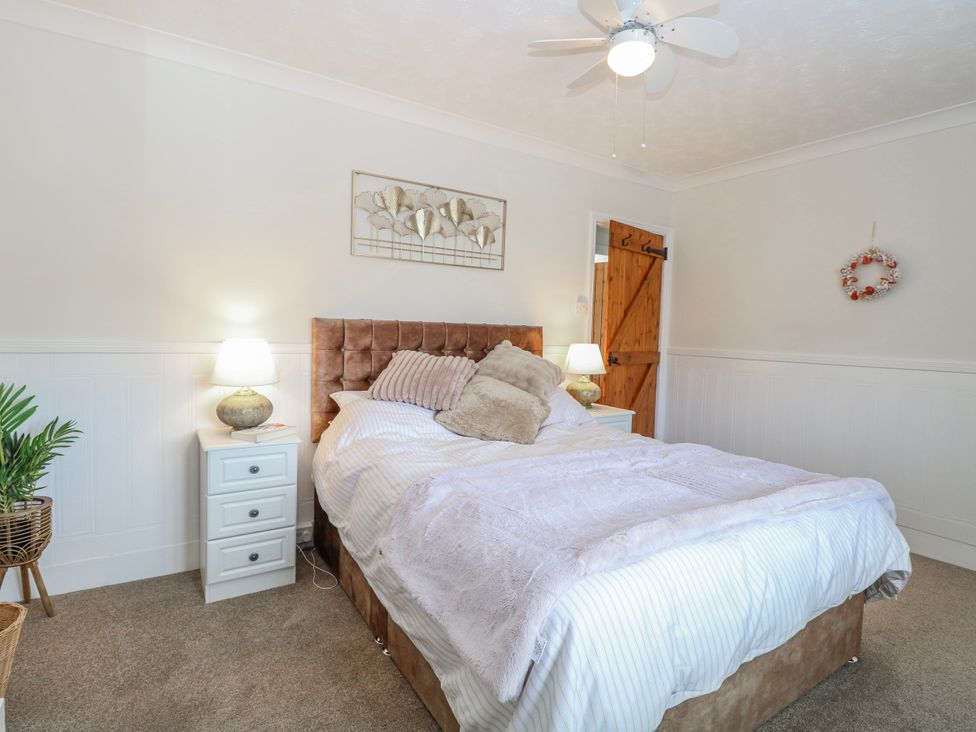 A bedroom with a bed and nightstand at 17 Woodside Avenue King's Lynn