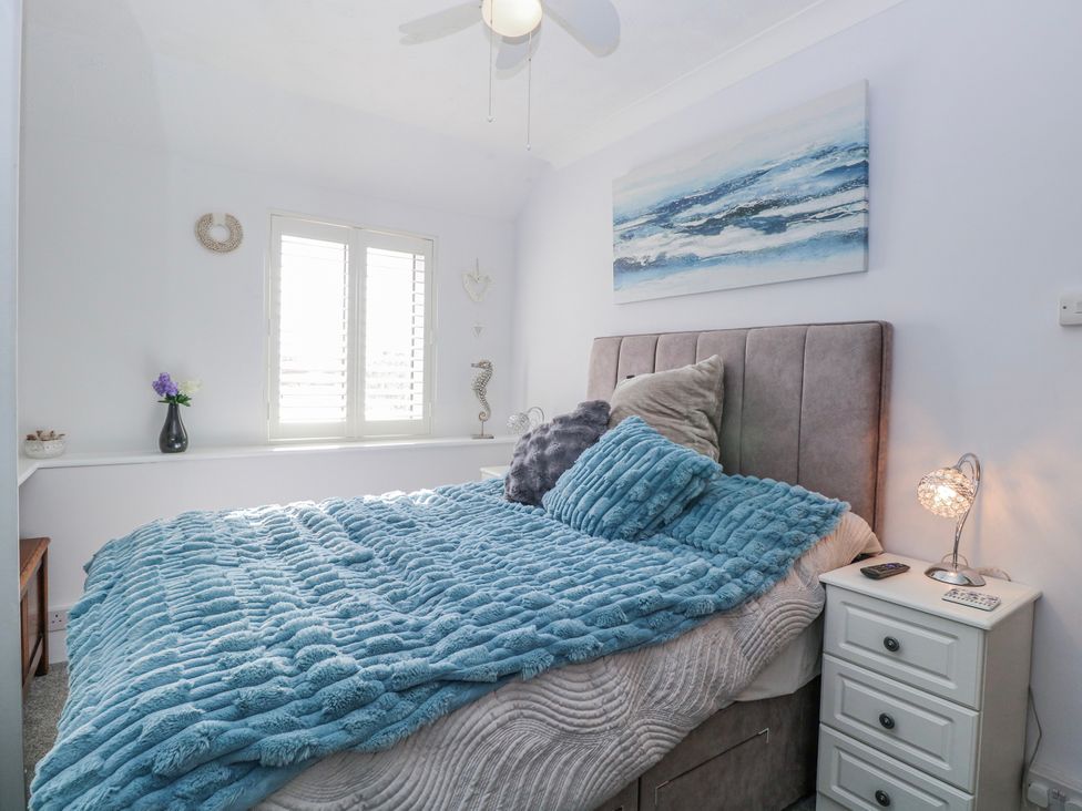 A bedroom with a bed and bedside table at 17 Woodside Avenue in King's Lynn