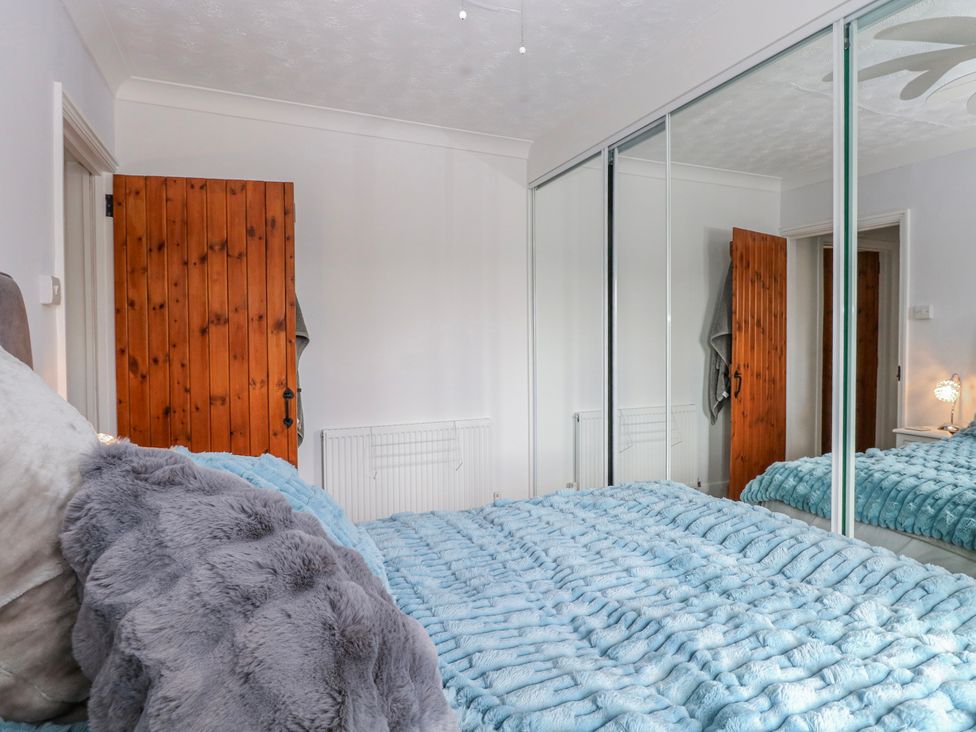 A bedroom with a bed and wardrobe at 17 Woodside Avenue in King's Lynn