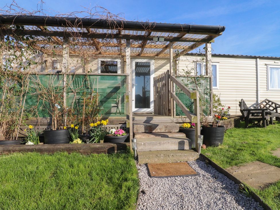 An outdoor entrance with steps and plants at Cornholme Lodge in Accrington