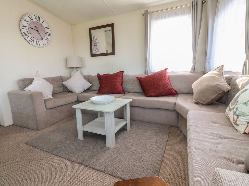 A living room with a sofa and coffee table at Cornholme Lodge in Accrington