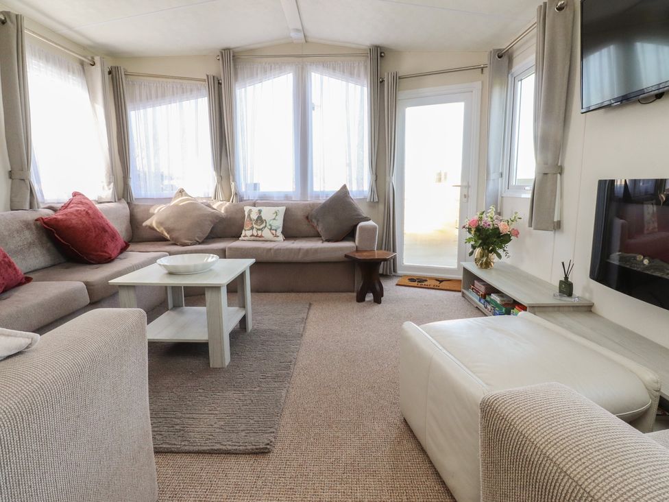 A living room with a sofa and coffee table at Cornholme Lodge in Accrington