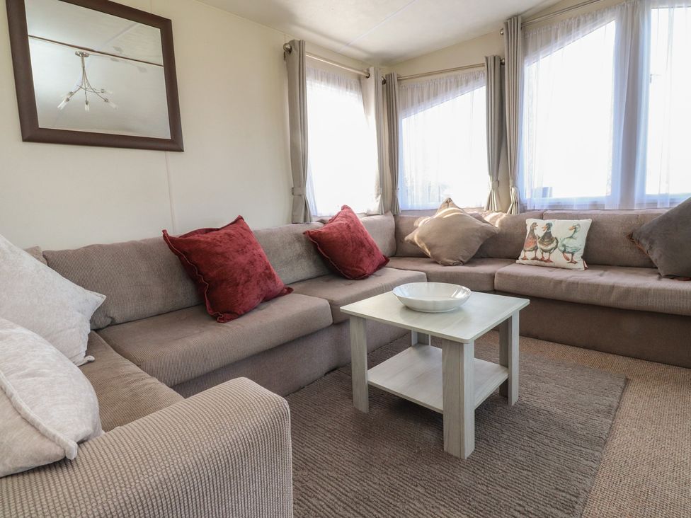A living room with a sofa and coffee table at Cornholme Lodge in Accrington