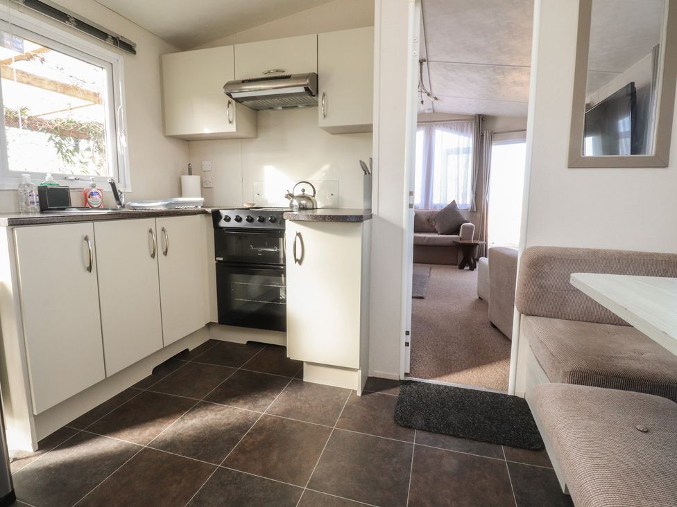 A kitchen with cabinets and oven at Cornholme Lodge in Accrington