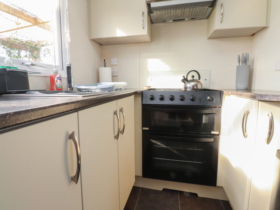 A kitchen with an oven and sink at Cornholme Lodge in Accrington