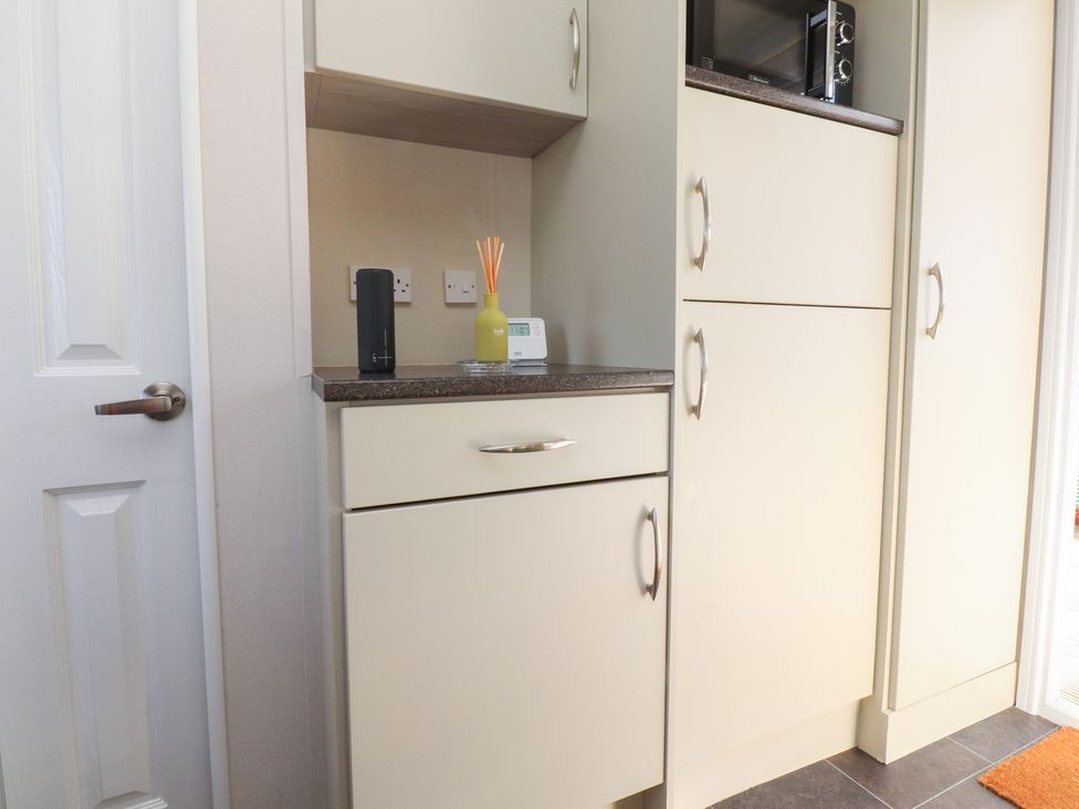 A kitchen with cabinets and appliances at Cornholme Lodge in Accrington
