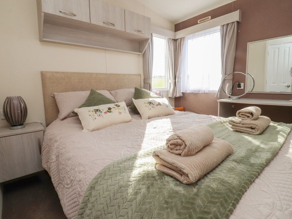 A bedroom with a bed and lamp at Cornholme Lodge in Accrington