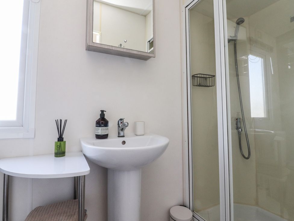 A bathroom with a sink and shower at Cornholme Lodge in Accrington