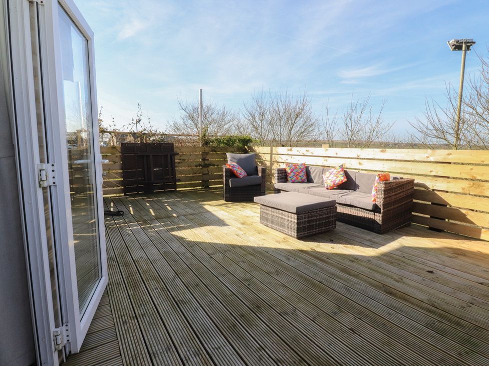 An outdoor area with a sofa and coffee table at Cornholme Lodge in Accrington