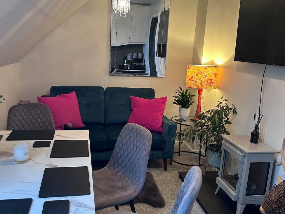 A living room with sofa and table at 3 Linshader in Stornoway