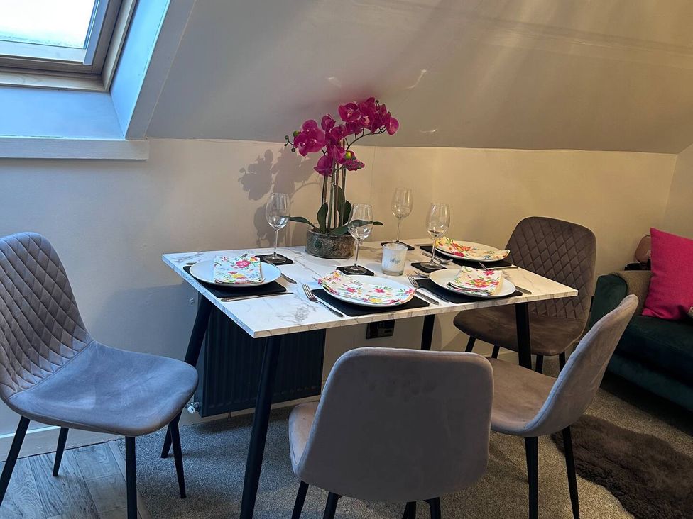 A dining room with a table set for four at 3 Linshader in Stornoway