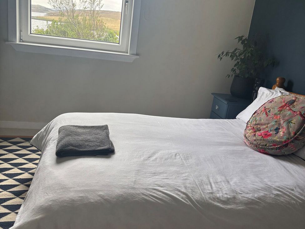 A bedroom with a bed and window at 3 Linshader, Stornoway