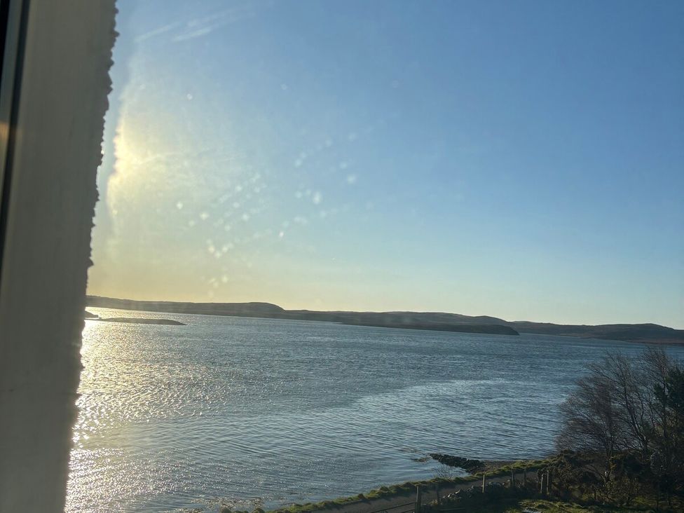 A view of water and hills under a clear sky at 3 Linshader in Stornoway