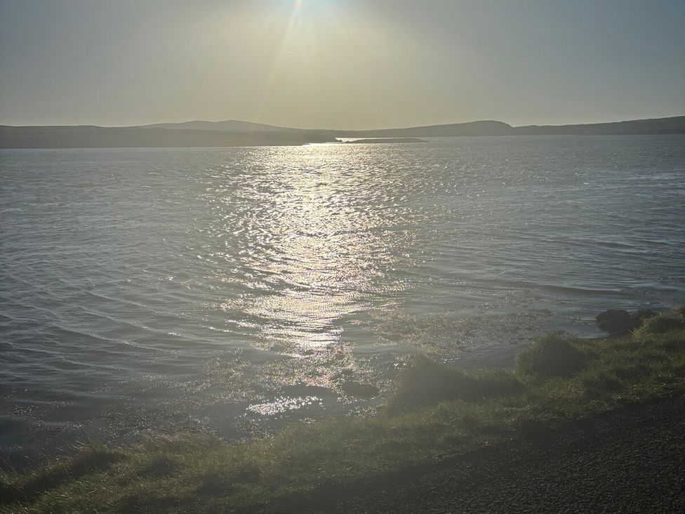 A landscape with water reflecting sunlight at 3 Linshader in Stornoway