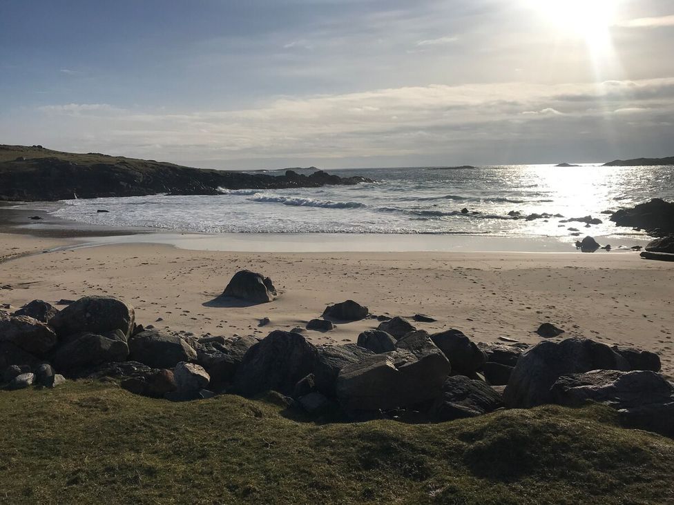 A beach with rocks and sea waves at 3 Linshader in Stornoway