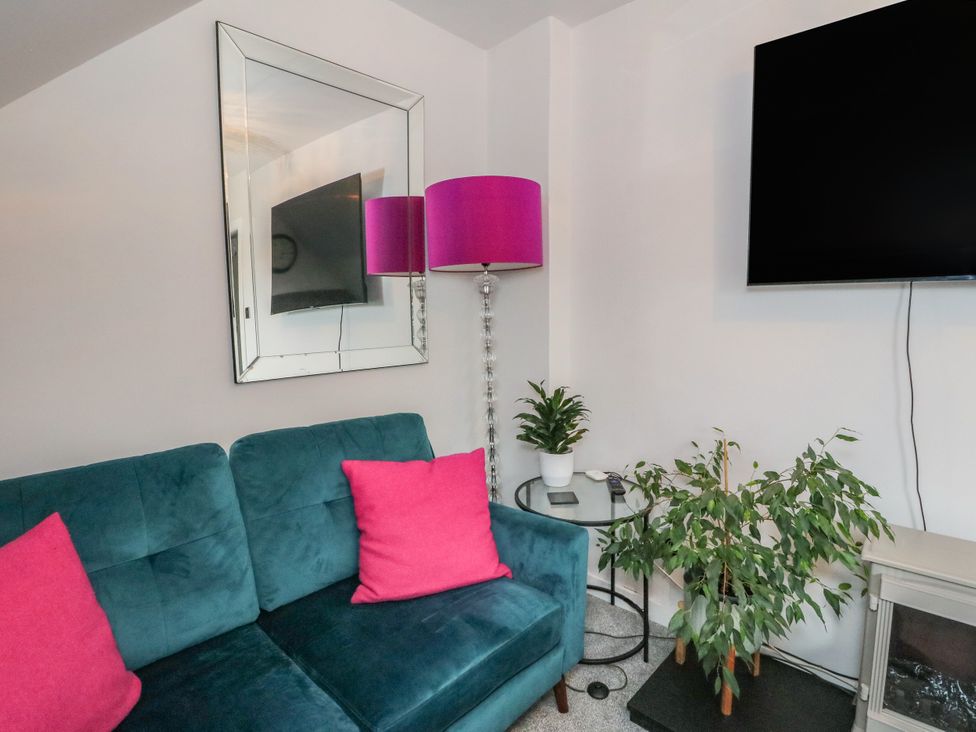 A living room with a sofa and TV at 3 Linshader in Stornoway