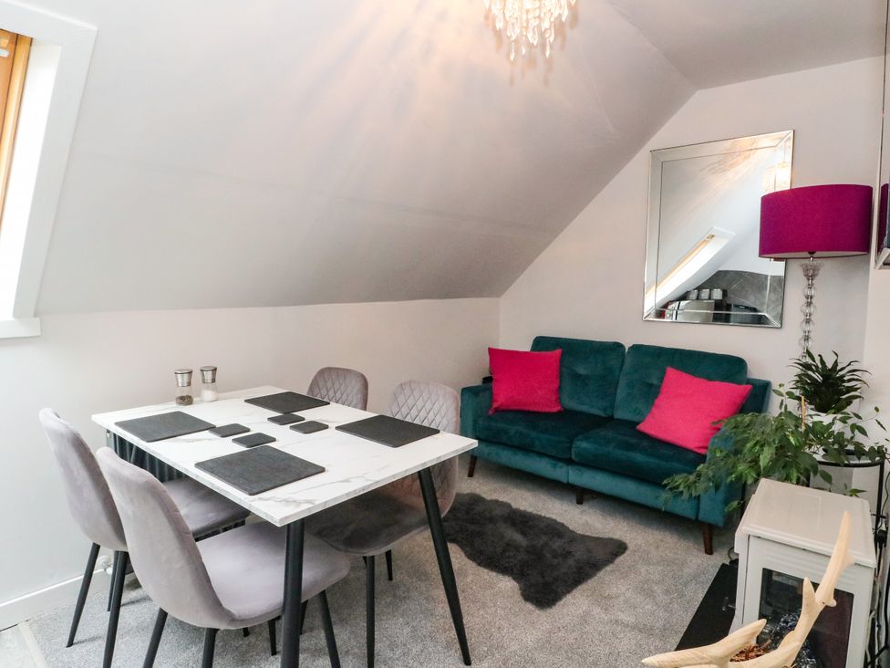 A dining room with a table and chairs at 3 Linshader, Stornoway