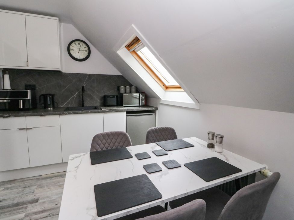 A kitchen with cabinets, countertop, and tableware at 3 Linshader, Stornoway