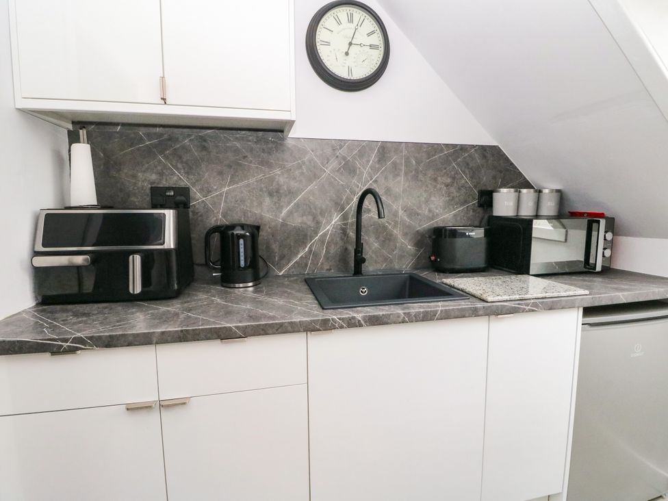 A kitchen with appliances and a sink at 3 Linshader in Stornoway