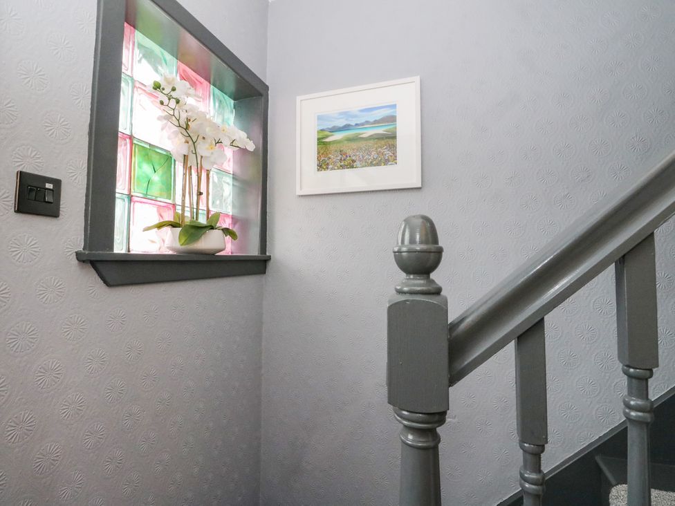 A stairway with a stained glass window and a framed picture at 3 Linshader Stornoway