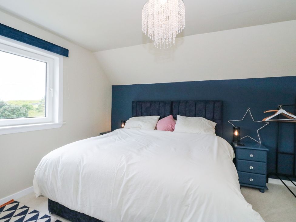 A bedroom with a bed and bedside table at 3 Linshader Stornoway