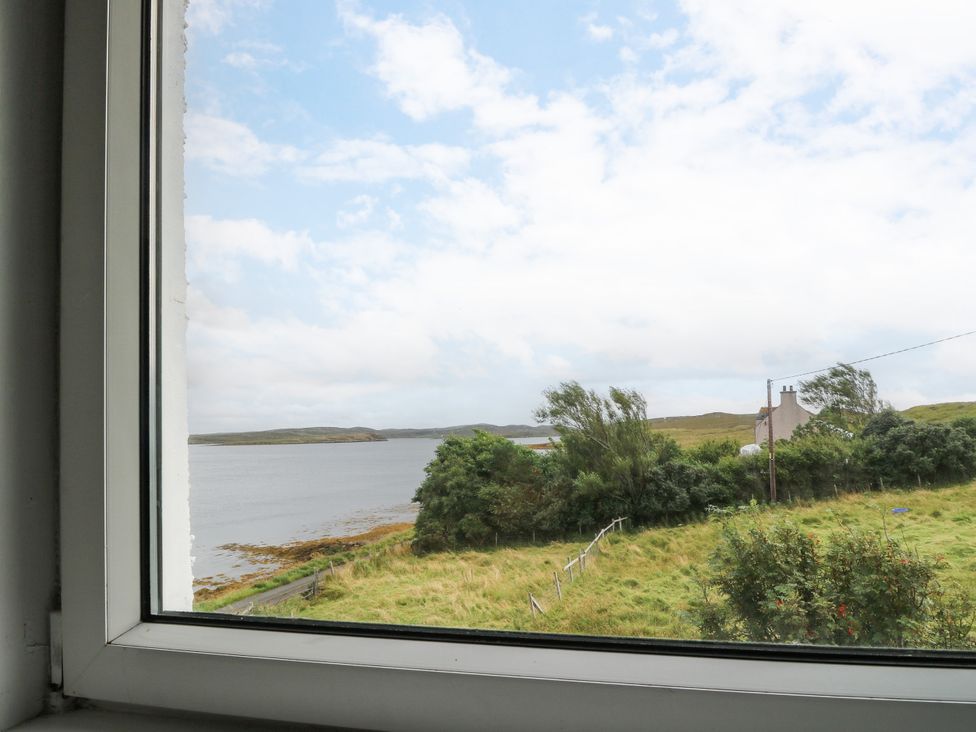 A view from a window showing water and greenery at 3 Linshader Stornoway