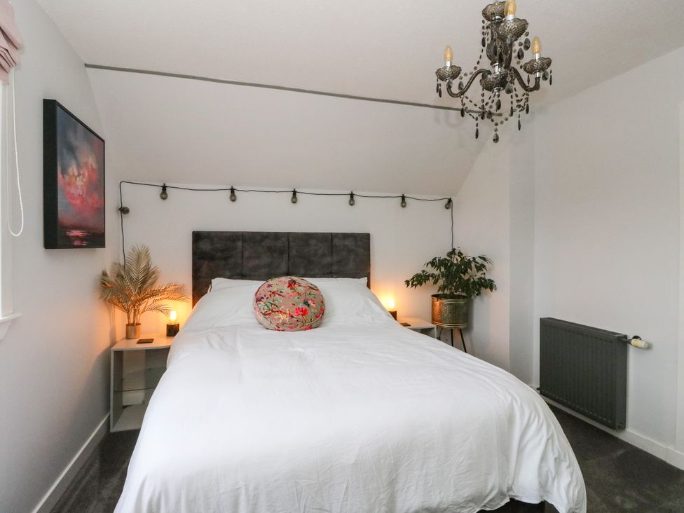 A bedroom with a bed and bedside table at 3 Linshader in Stornoway