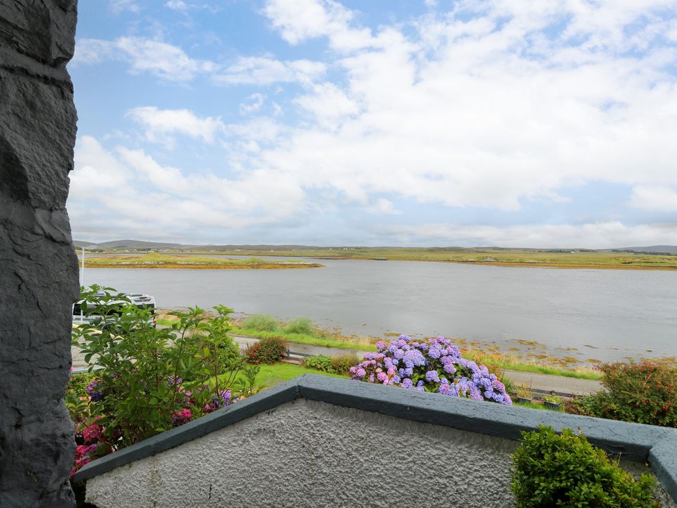A view of a river and flowers from a property at 3 Linshader Stornoway