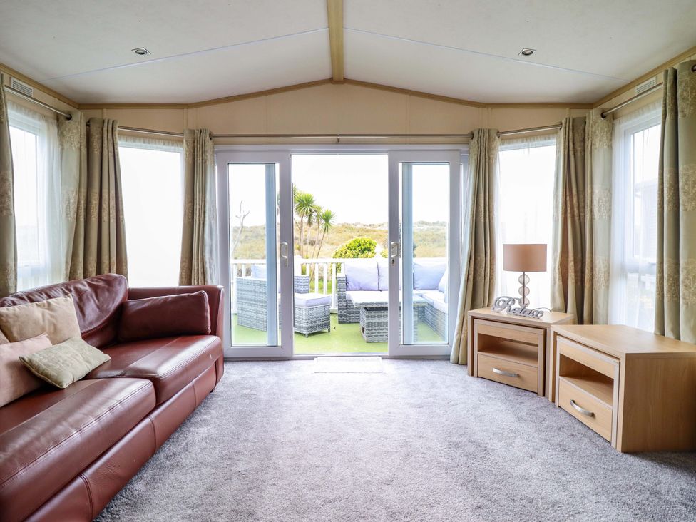 A living room with a sofa and table at Pemberton Knightsbridge in Morfa Bychan
