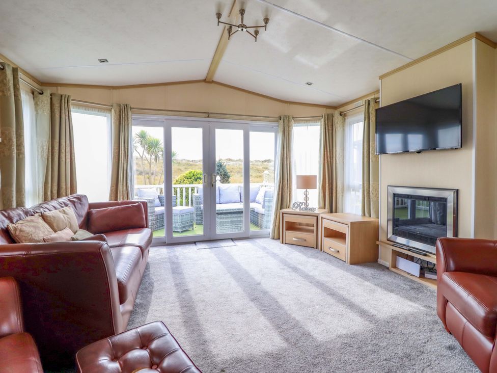 A living room with sofas and a television at Pemberton Knightsbridge in Morfa Bychan