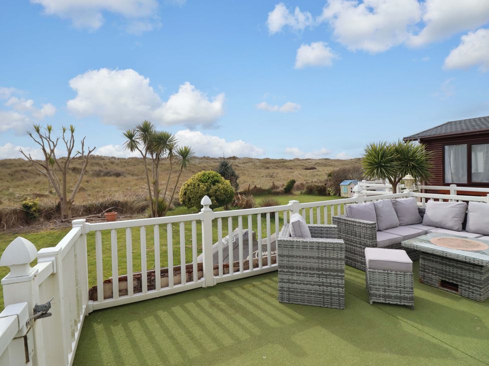 An outdoor seating area with a couch and table at Pemberton Knightsbridge Morfa Bychan