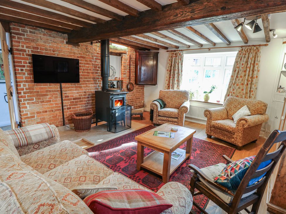 A living room with a sofa and armchairs at 5 Castle Street in Newport, Isle Of Wight