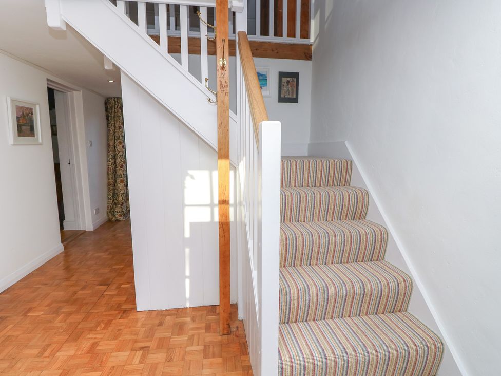 A hallway with stairs and a door at 5 Castle Street, Newport, Isle Of Wight