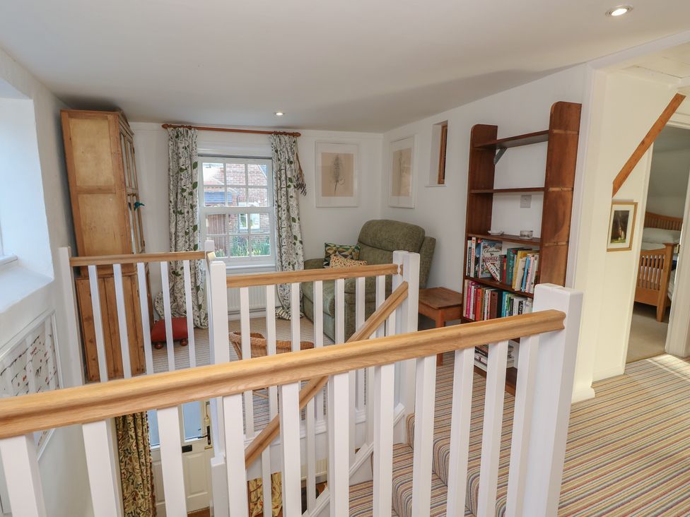 A landing with a sofa and bookshelf at 5 Castle Street, Newport, Isle Of Wight