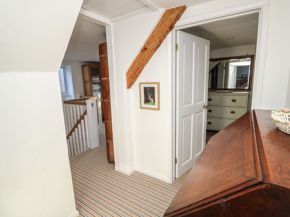 A hallway with a staircase and a door at 5 Castle Street, Newport, Isle Of Wight