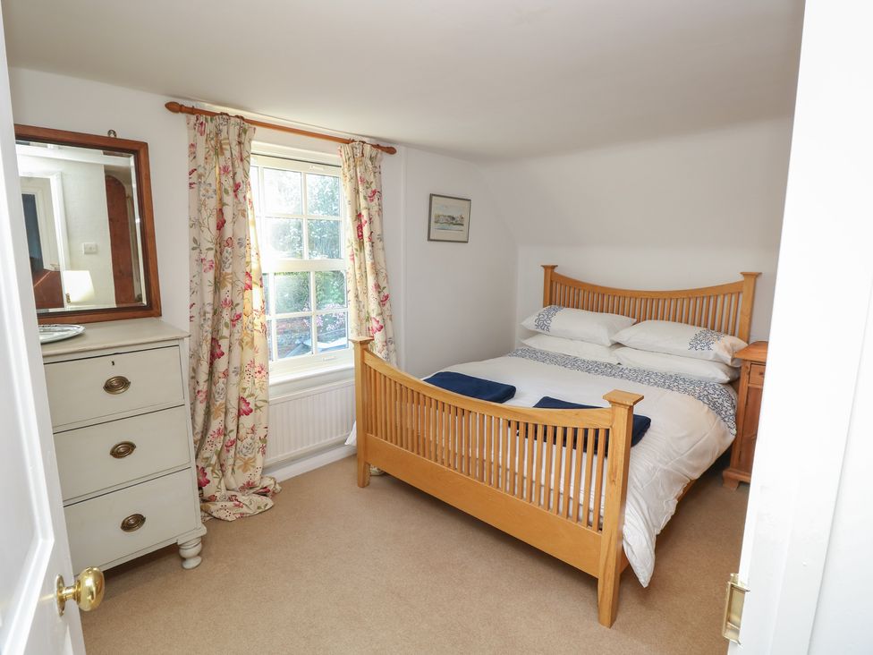 A bedroom with a bed and dresser at 5 Castle Street, Newport, Isle Of Wight