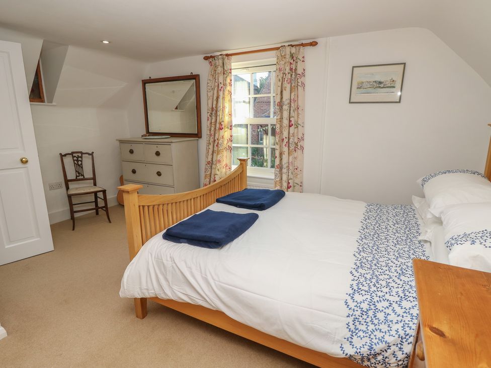 A bedroom with a bed and chair at 5 Castle Street, Newport, Isle Of Wight
