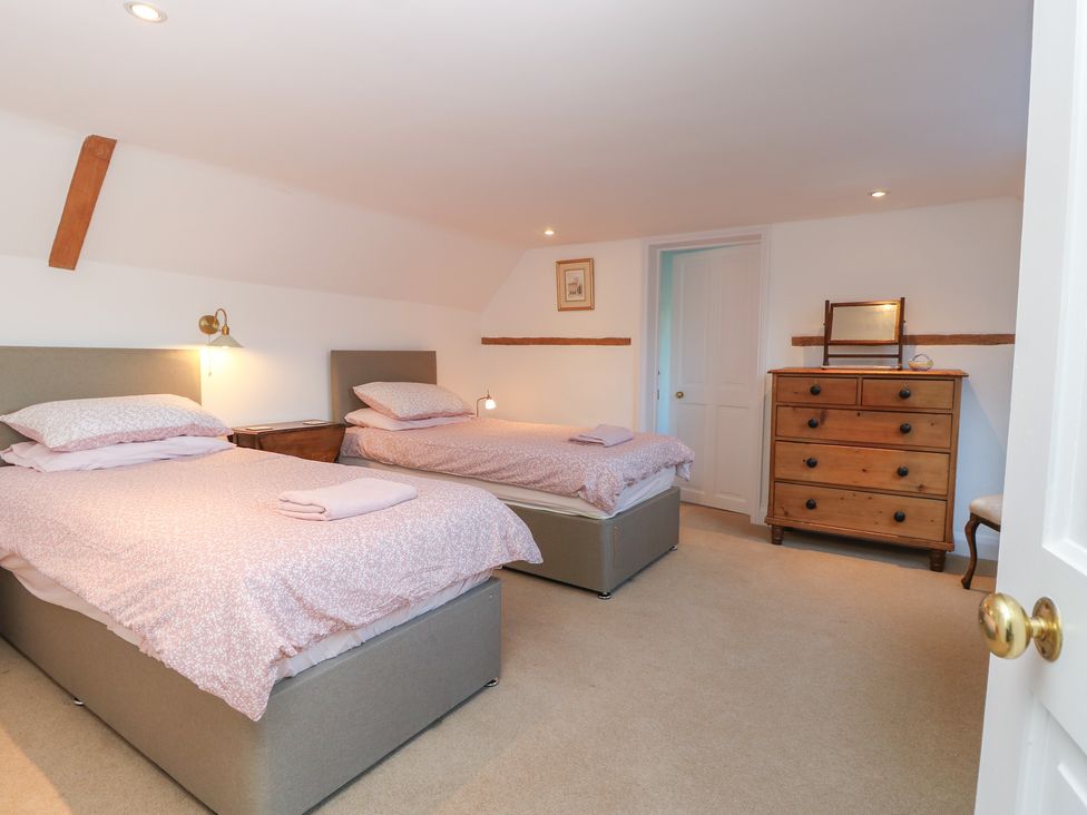 A bedroom with two beds and a dresser at 5 Castle Street, Newport, Isle Of Wight