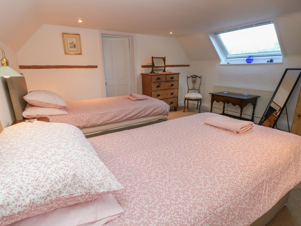 A bedroom with two beds and a dresser at 5 Castle Street, Newport, Isle Of Wight