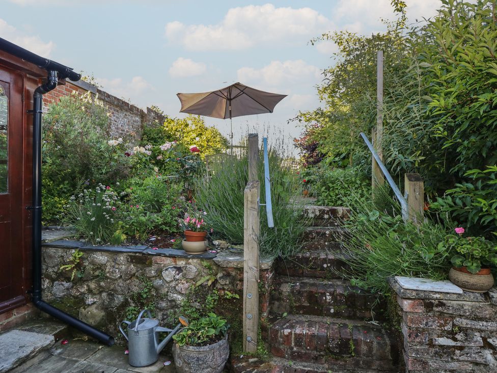 A garden with stairs and a parasol at 5 Castle Street, Newport, Isle Of Wight