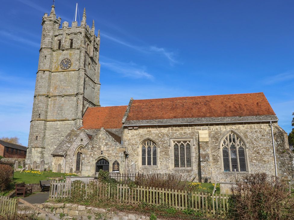 A church with a clock tower and surrounding greenery at 5 Castle Street Newport, Isle Of Wight
