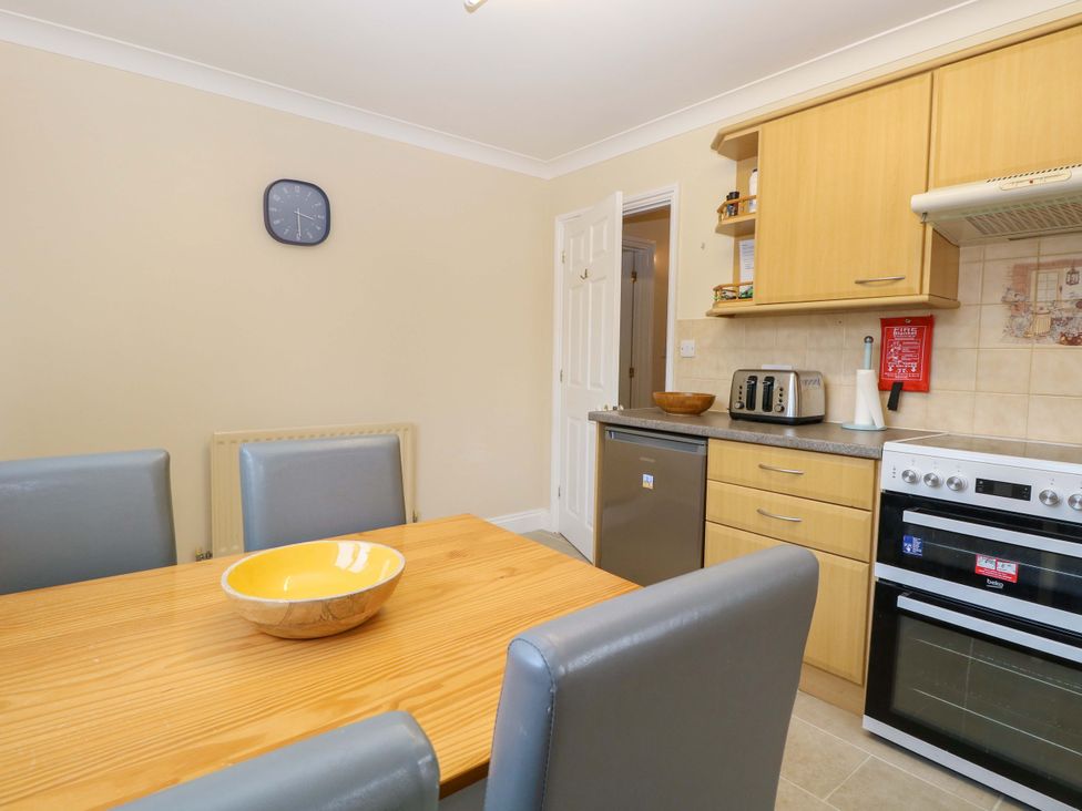 A kitchen with a table and chairs at The Bungalow