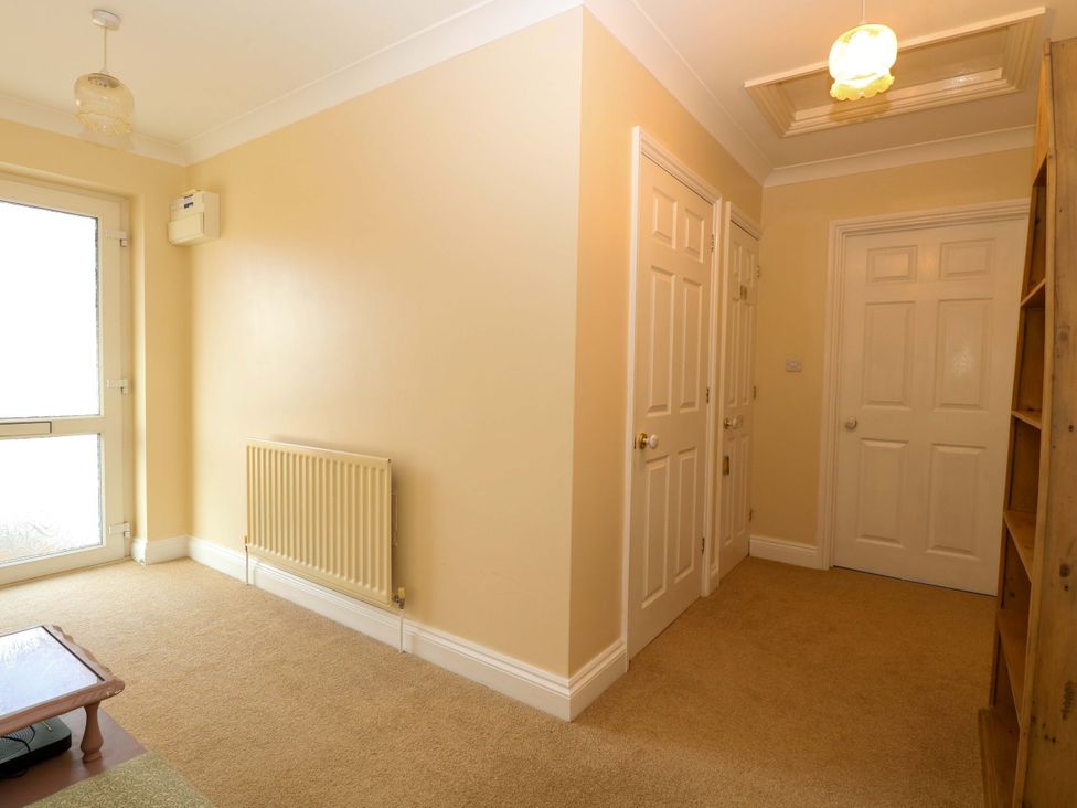 A hallway with a door and radiator at The Bungalow in 