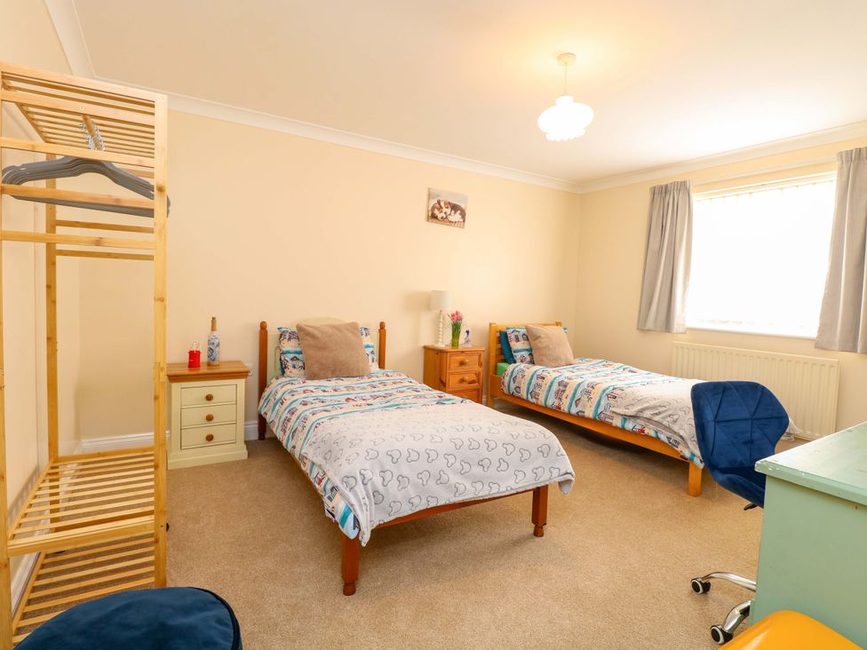 A bedroom with two beds and a bedside table at The Bungalow 
