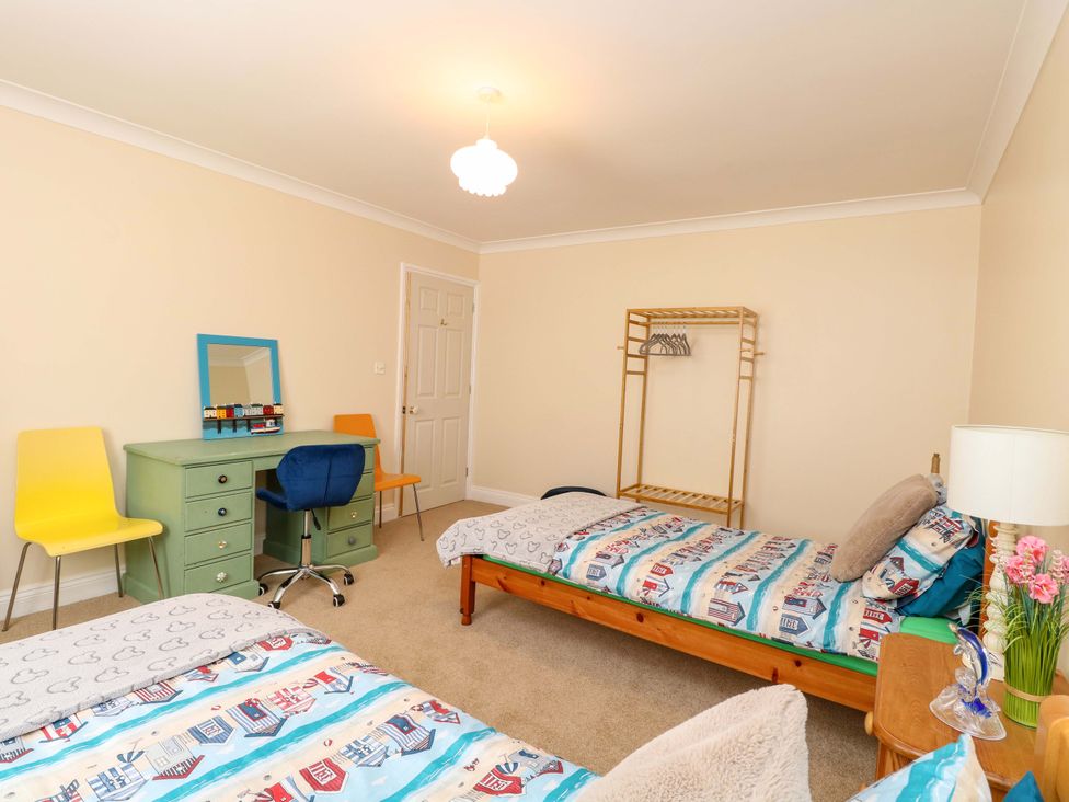 A bedroom with two beds and a desk at The Bungalow
