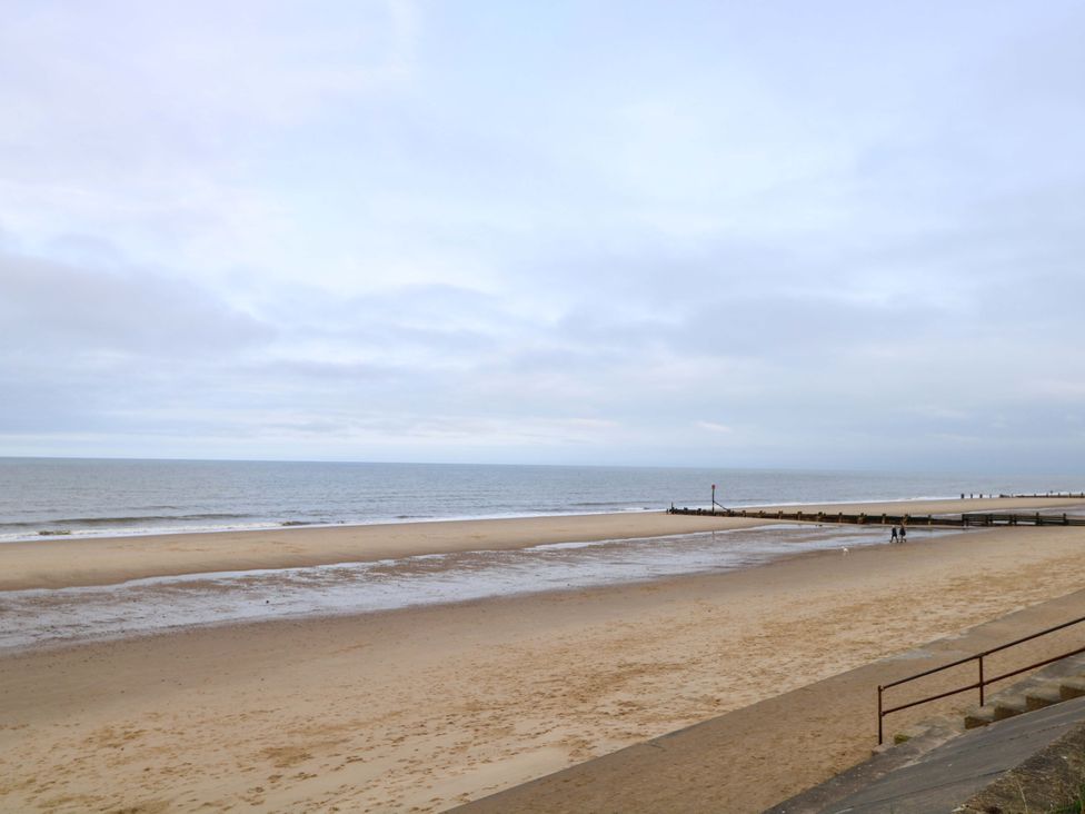 A beach with sand and ocean at The Bungalow in 