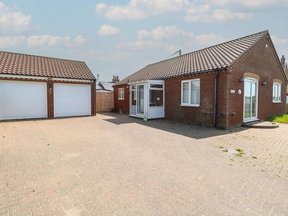 A bungalow with a driveway and garage at The Bungalow Walcott