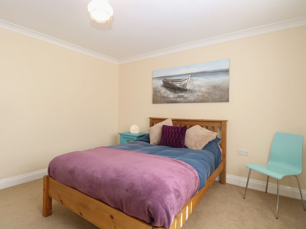 A bedroom with a bed and painting at The Bungalow in Walcott